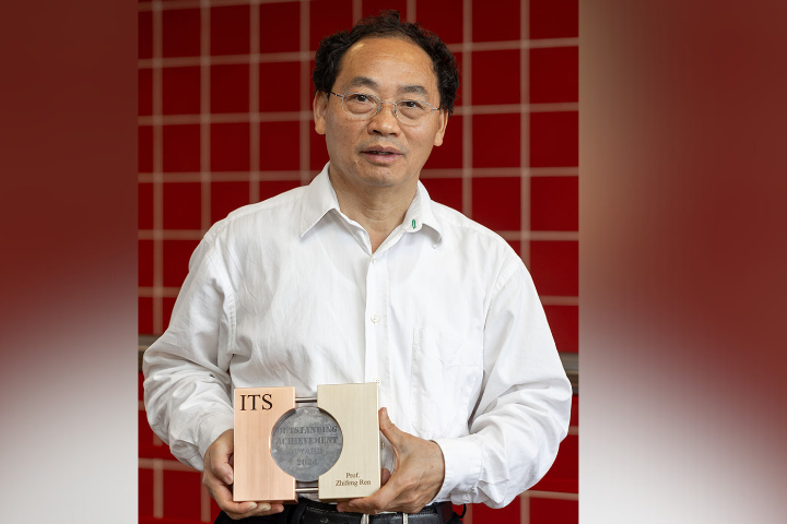 Picture of Professor Zhifeng Ren posing with his award from the International Thermoelectric Society