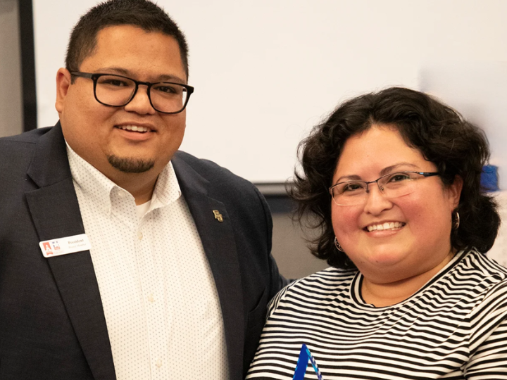 Picture of Erica Casillas recieving an award from a member of the Texas Association of Graduate Admission Professionals