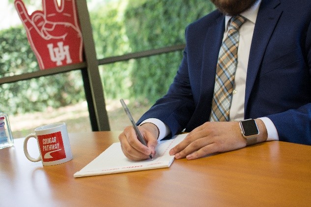 employer in suit and tie taking notes