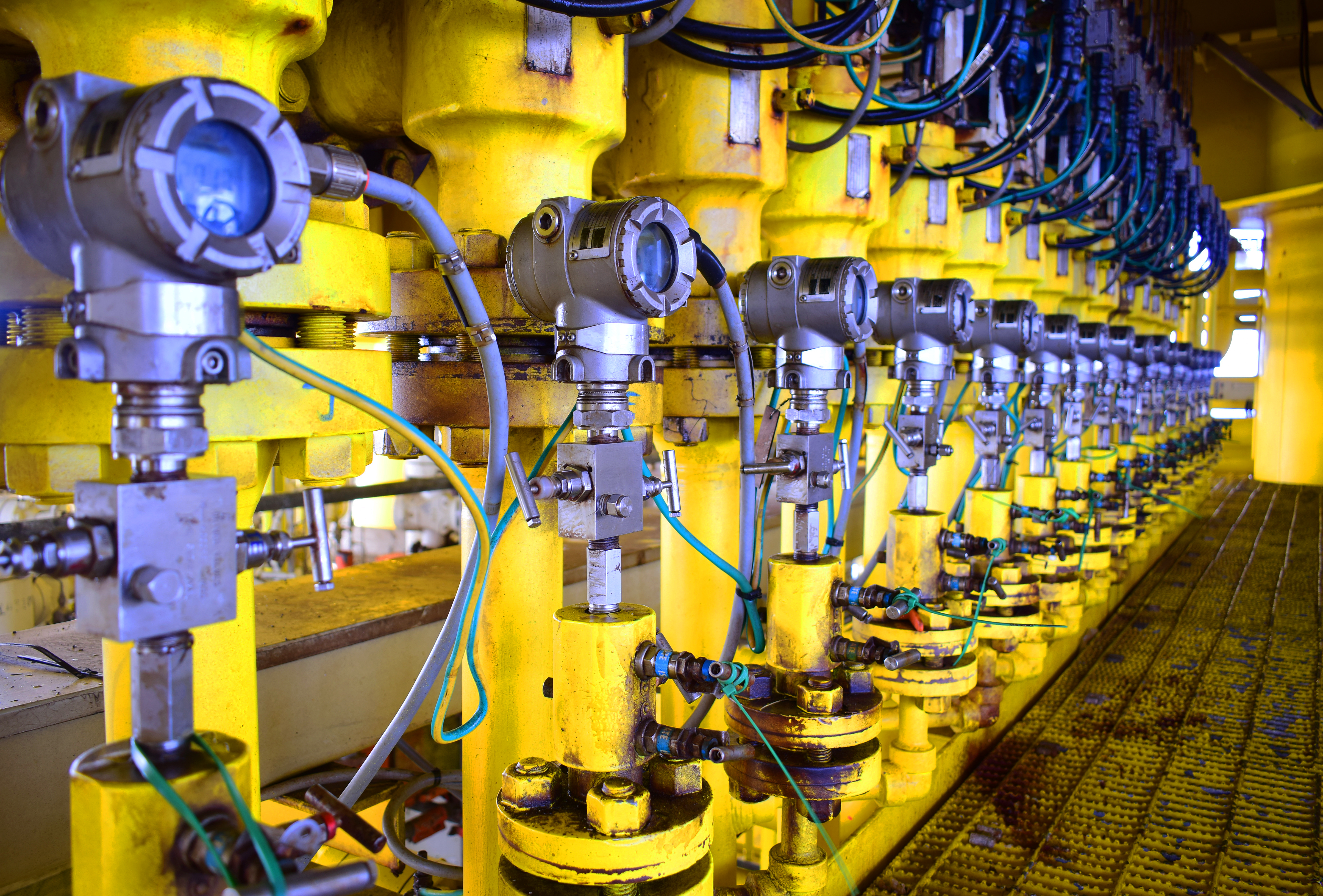 Image of a row of oil gauges at an oil refinery